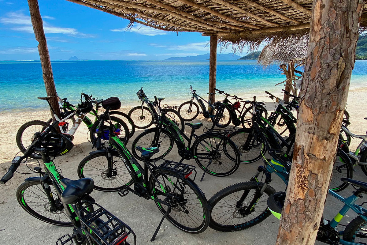 Electrical-assisted bicycles on the beach of Temaruao in Raiatea